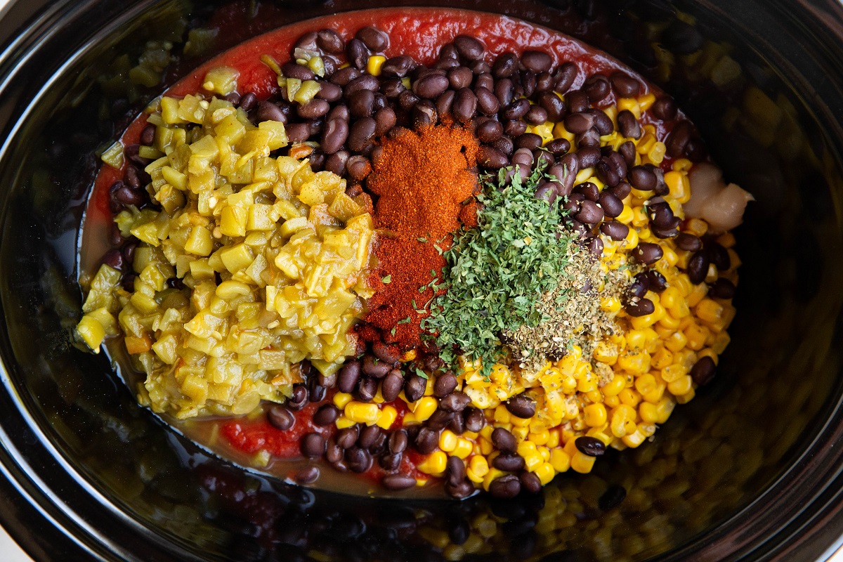 Crock pot chicken tortilla soup ingredients in a slow cooker, ready to be mixed.