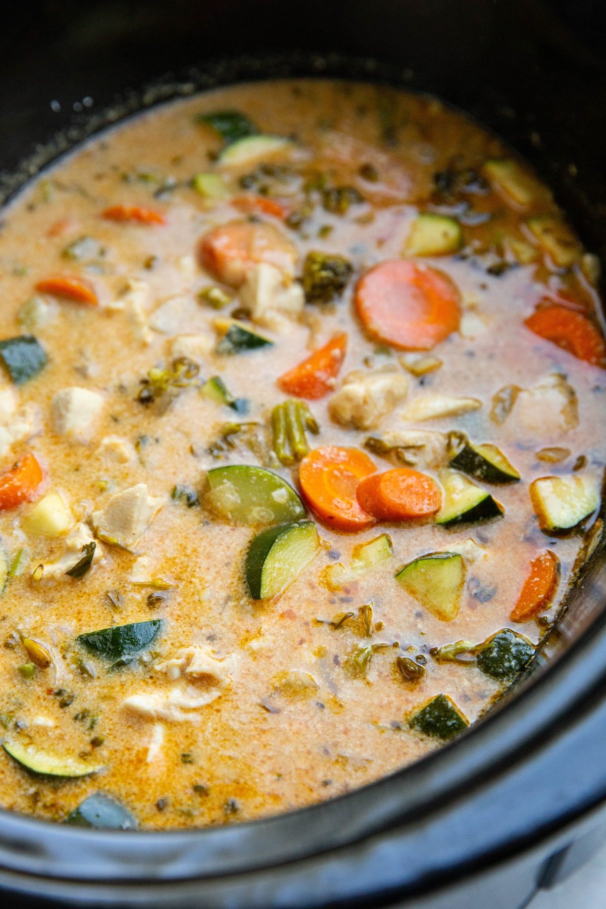 Crock Pot Thai Red Curry Chicken in a slow cooker, ready to serve and eat.