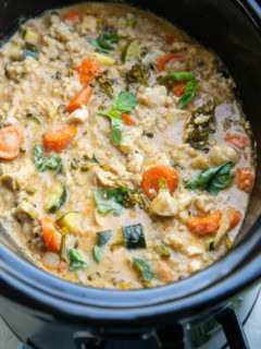 Slow cooker full of chicken curry with vegetables.