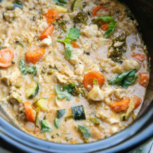 Slow cooker full of chicken curry with vegetables.