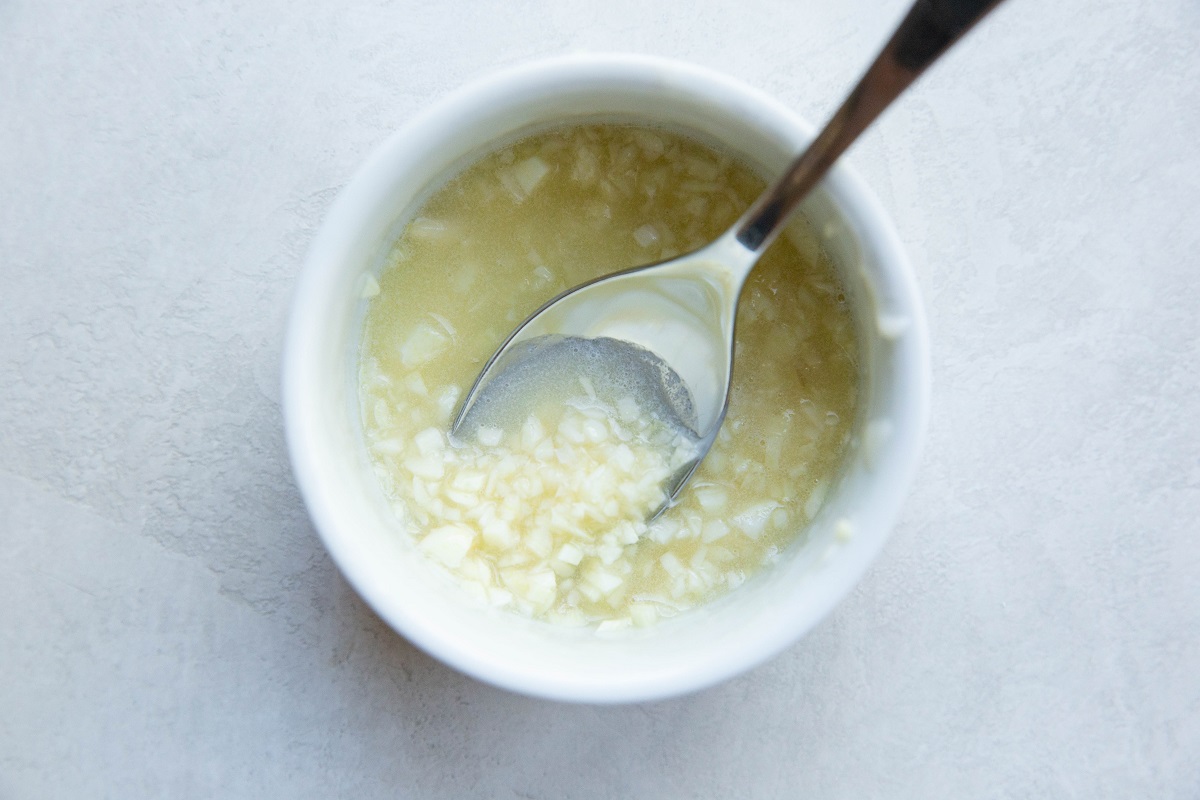 Garlic and butter mixed together in a small bowl.