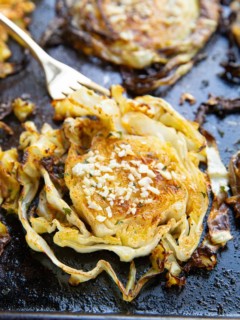 Finished cabbage fresh out of the oven with a fork, ready to eat.