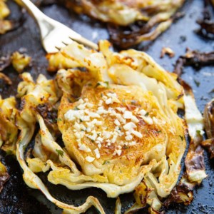 Finished cabbage fresh out of the oven with a fork, ready to eat.