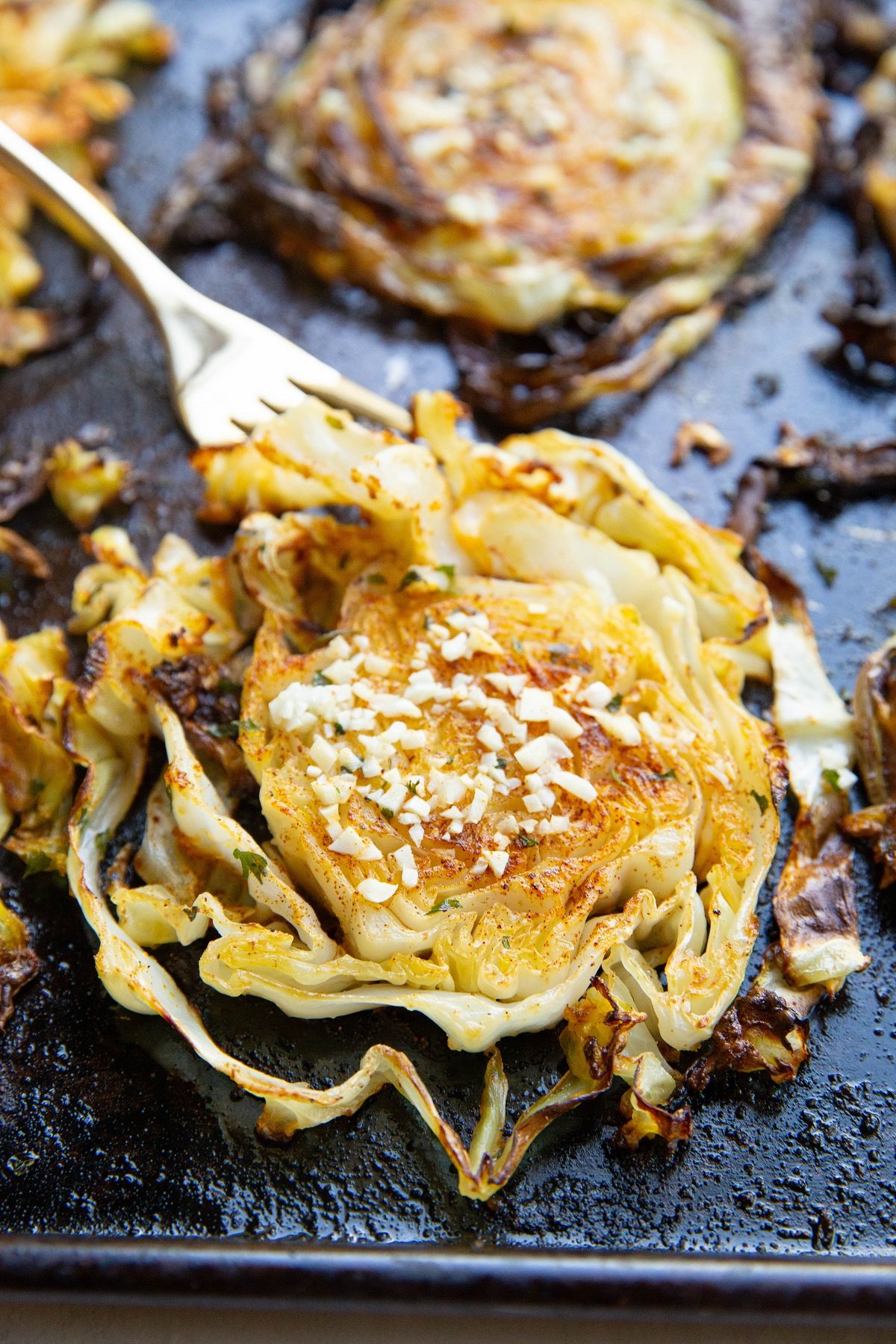 Finished cabbage fresh out of the oven with a fork, ready to eat.