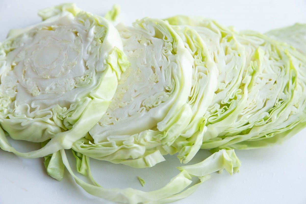 Cabbage wedges on a cutting board to make roasted cabbage steaks