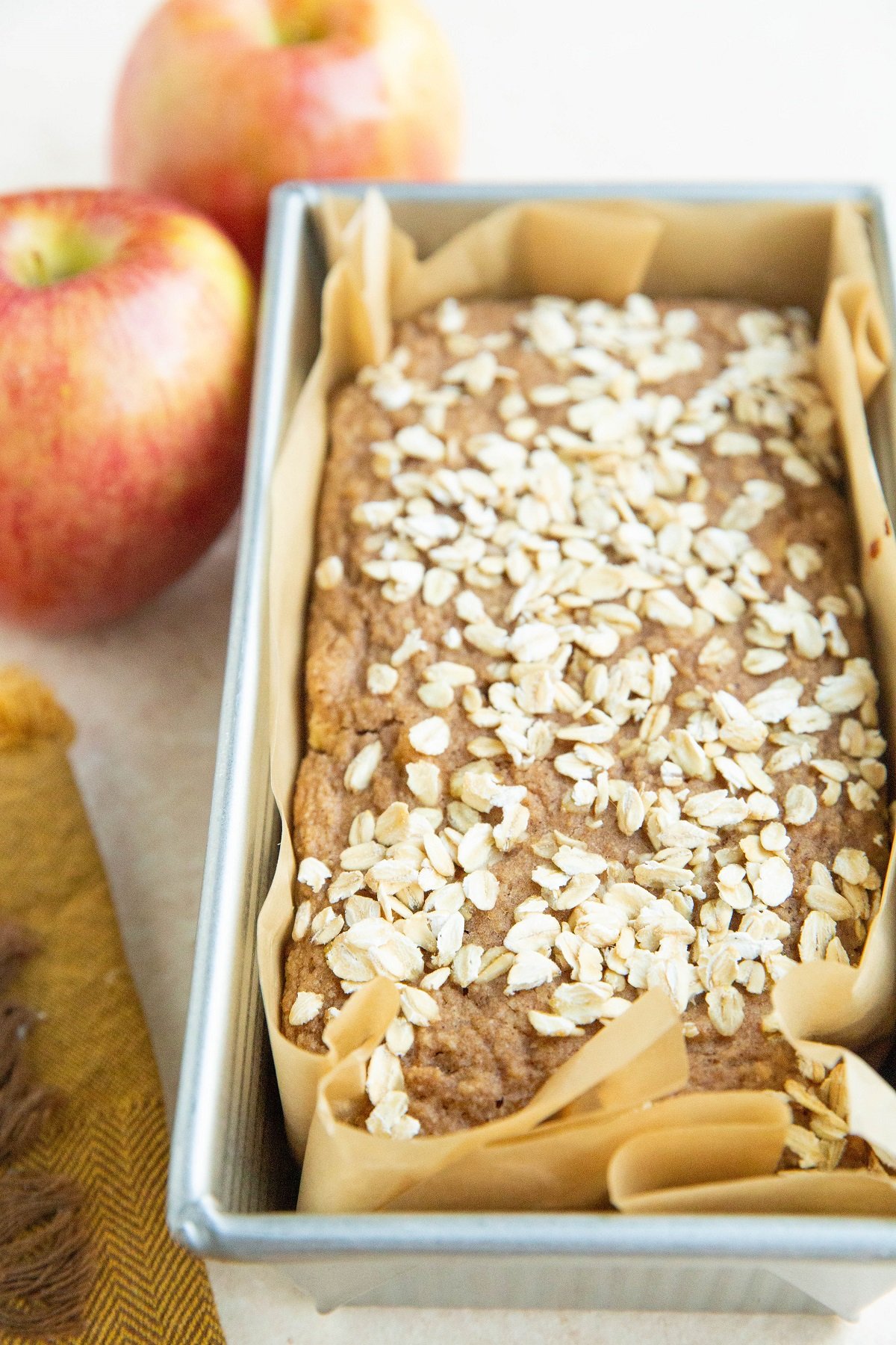 Loaf pan of oatmeal apple bread, fresh out of the oven.