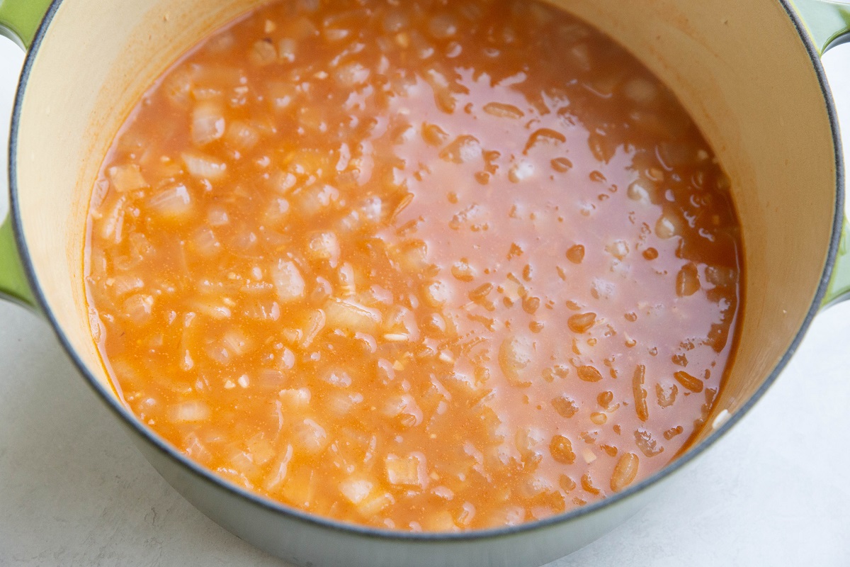 Ingredients for Mexican rice in a large pot.