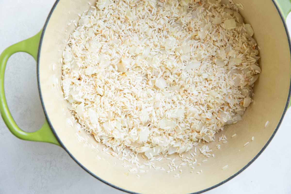 Rice and onion cooking in a large pot