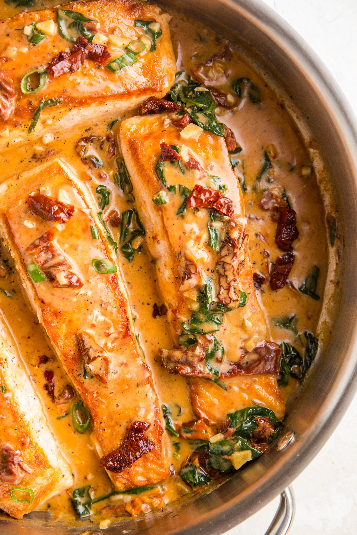 Creamy sun-dried tomato salmon in a skillet, ready to be served