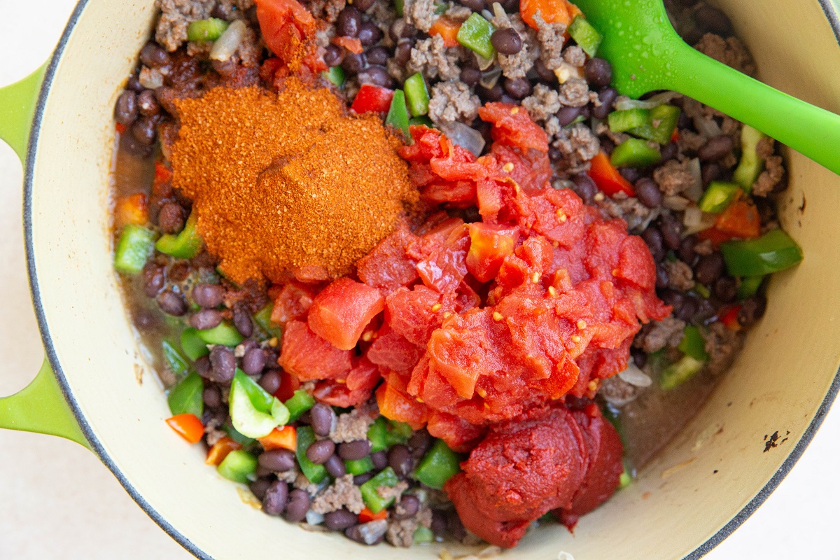 ground venison, onion, black beans, bell peppers, diced tomatoes, tomato paste, and chili powder in a large soup pot.