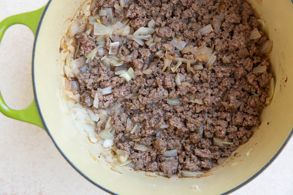 Venison and onion cooking in a Dutch oven.