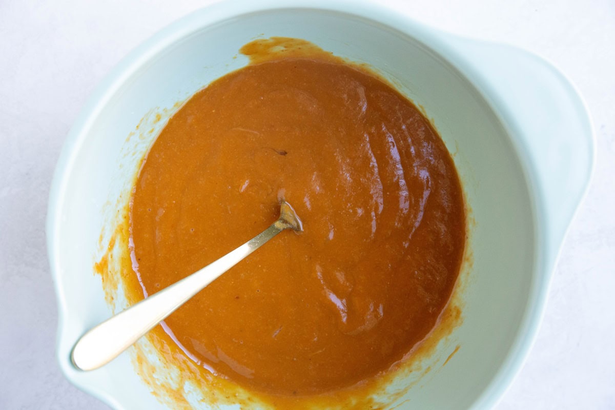 Wet ingredients for almond flour pumpkin muffins in a mixing bowl.