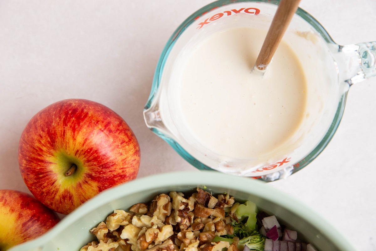 creamy dressing mixed up in a measuring cup for broccoli salad