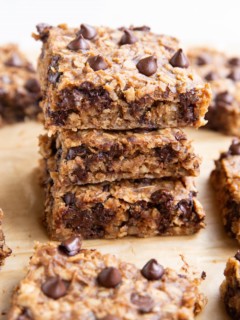Three oatmeal peanut butter banana bars stacked on top of each other.