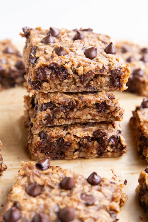 Three oatmeal peanut butter banana bars stacked on top of each other.