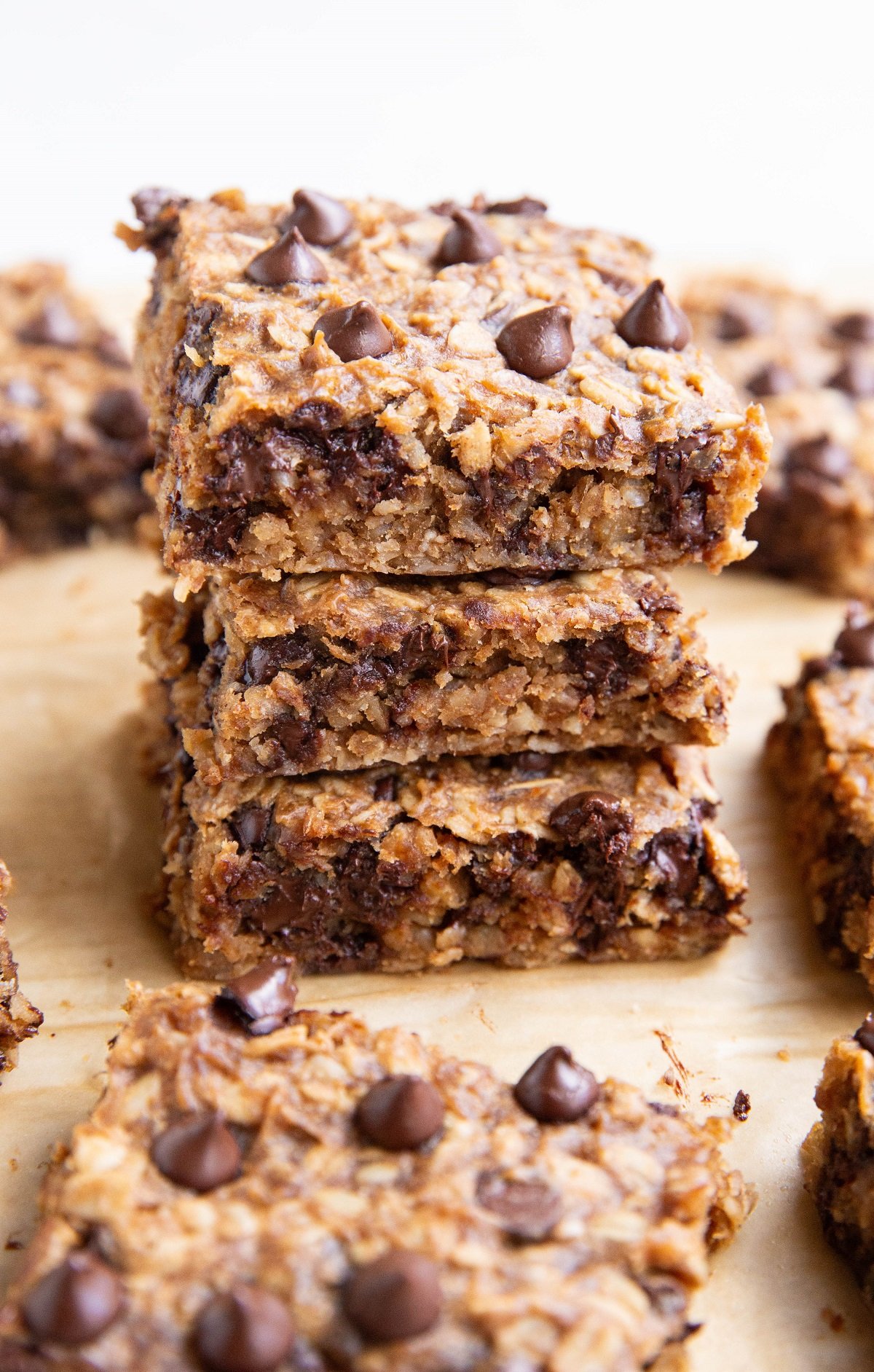 Three oatmeal peanut butter banana bars stacked on top of each other.