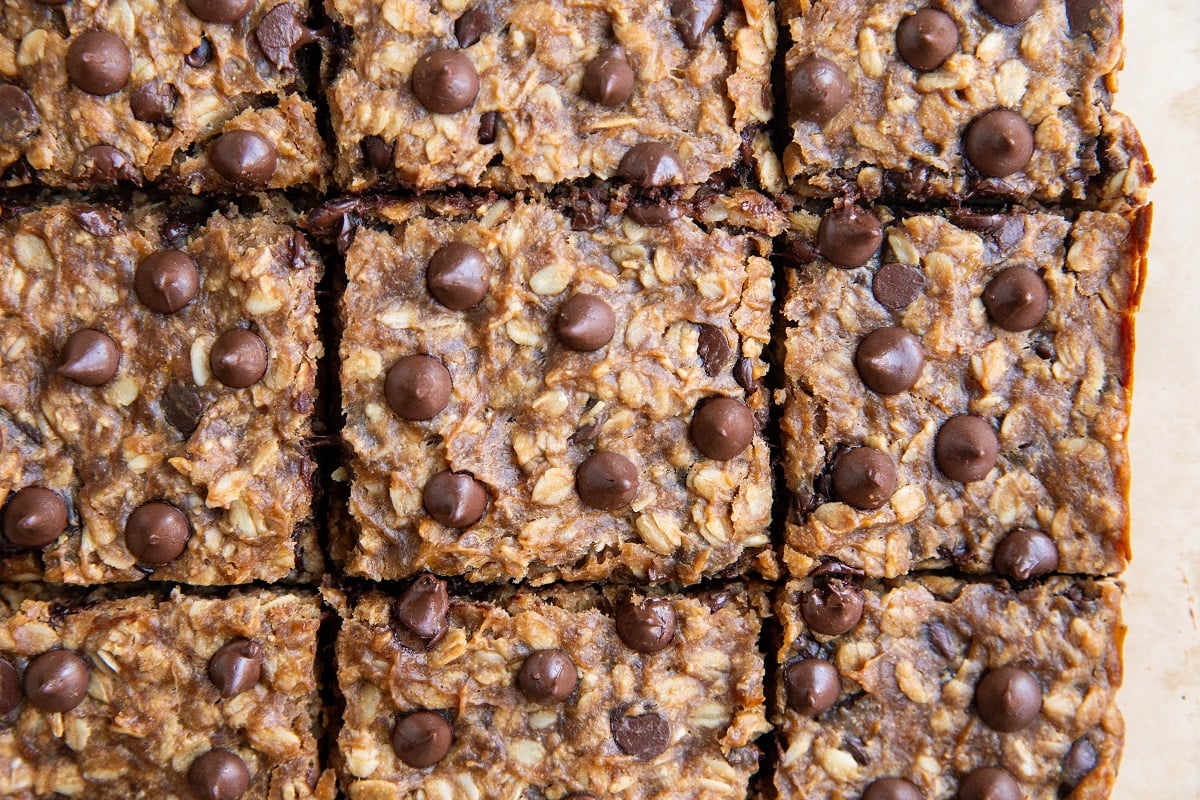 Slices of banana oat bars on a sheet of parchment paper.