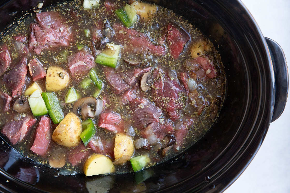 Ingredients for steak and potato soup in a crock pot.