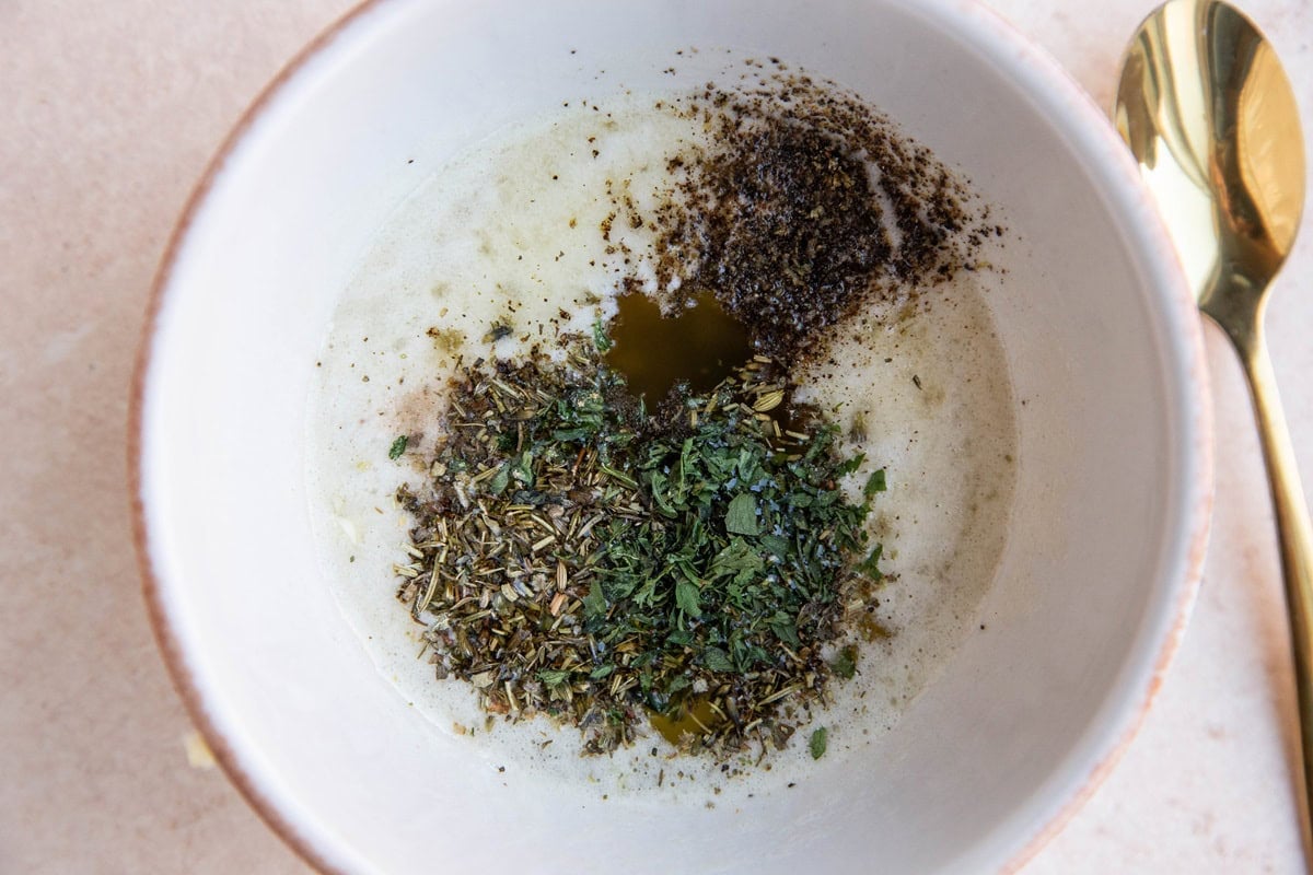 Ingredients for garlic butter sauce for chicken in a white bowl, ready to be stirred up.