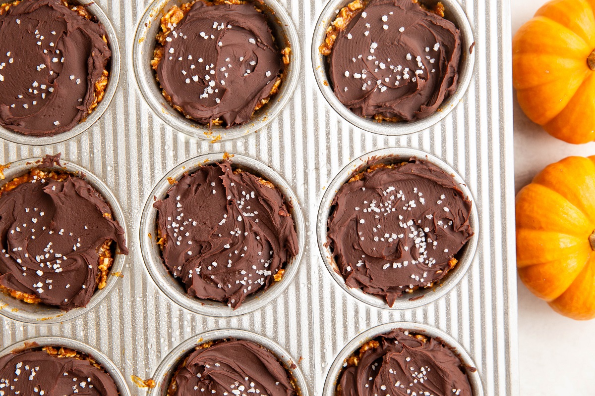 Pumpkin oatmeal cups with melted chocolate on top, ready to eat, fresh out of the freezer.