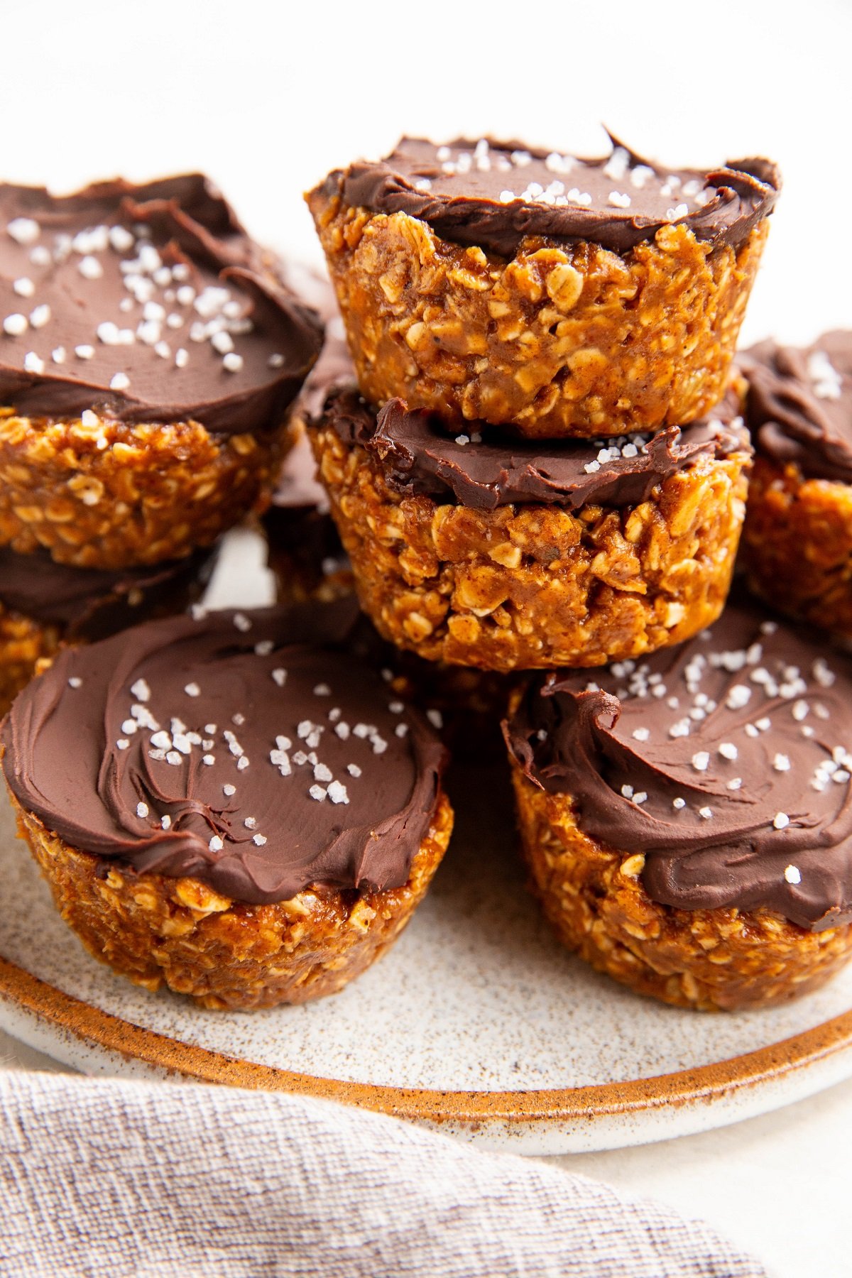 Plate of pumpkin oatmeal cups with chocolate layer on top.