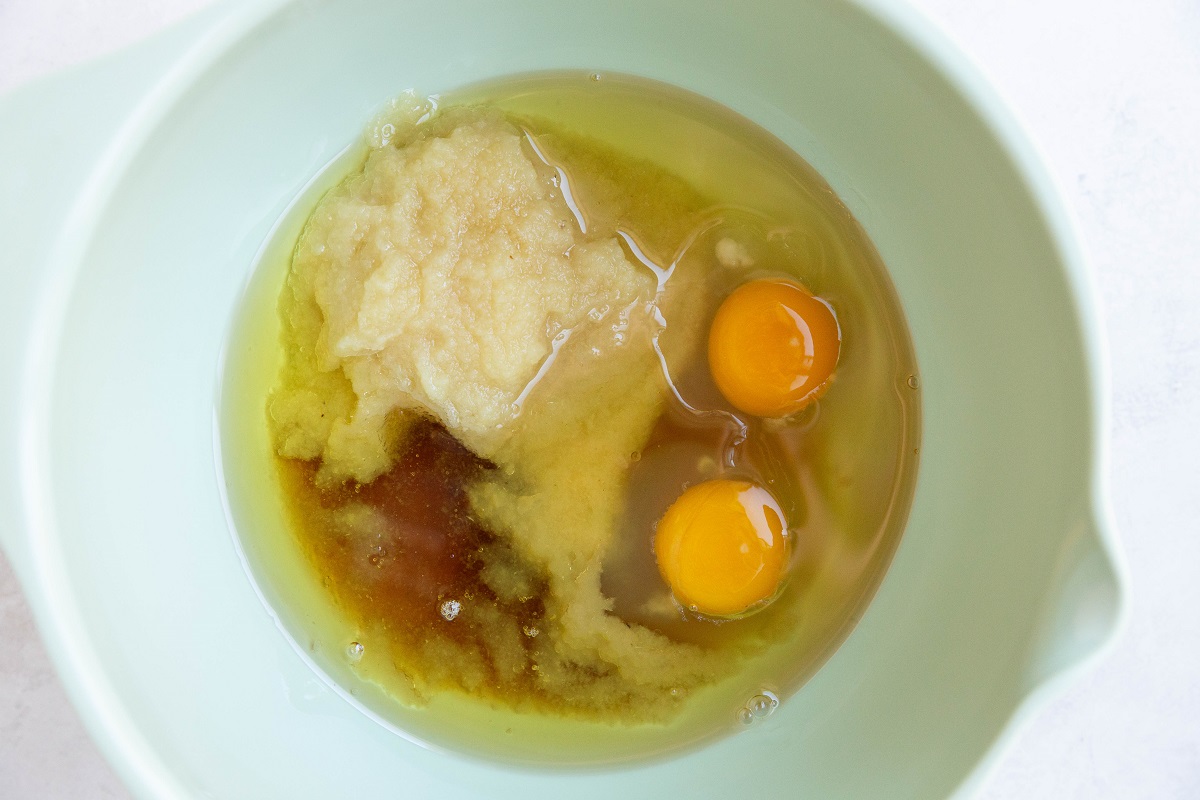 Wet ingredients for apple breakfast cake s in a mixing bowl.