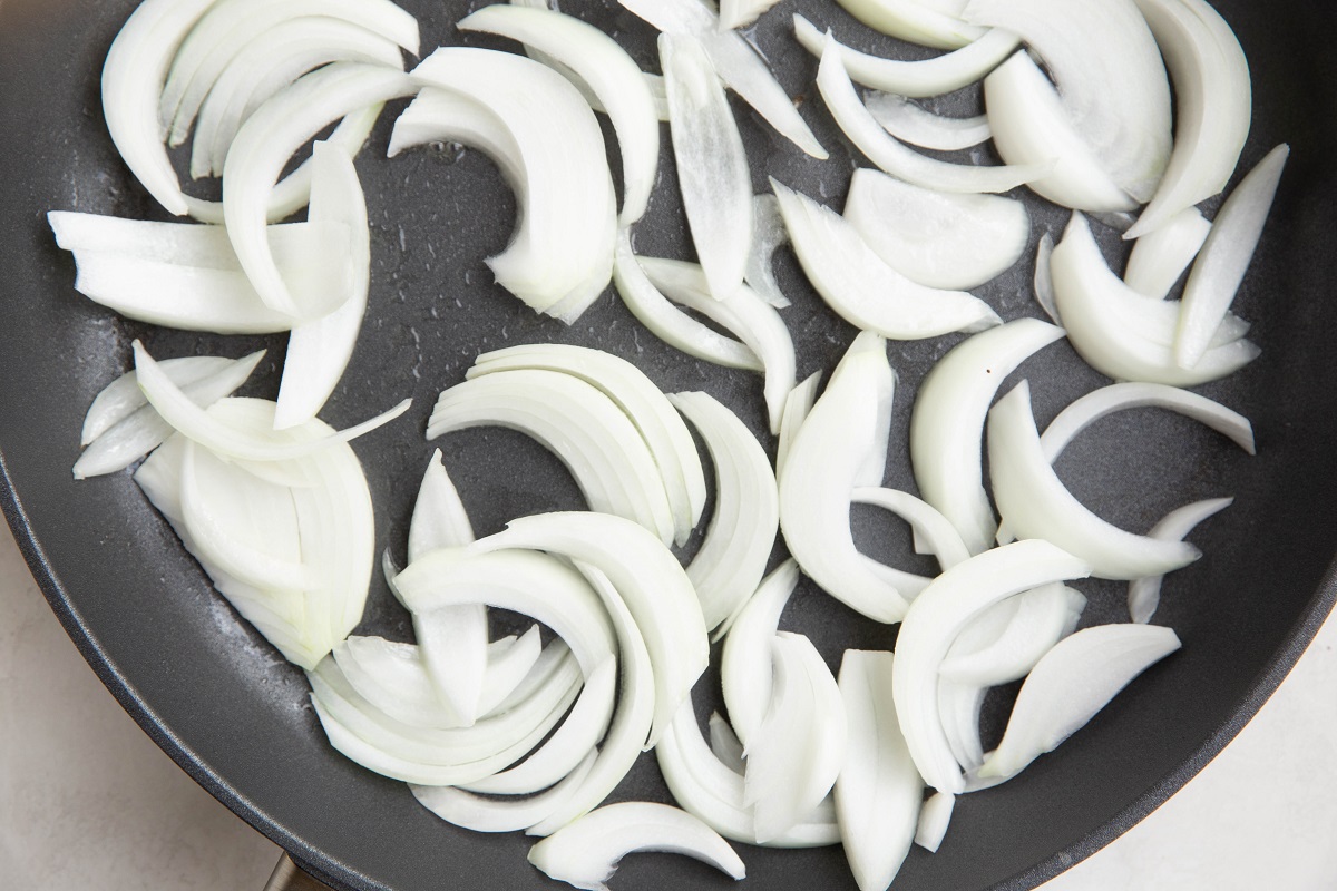 Onions stir frying in a large skillet