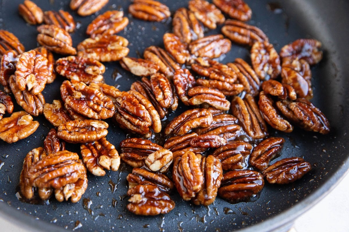Candied pecans in a skillet, ready to be used.