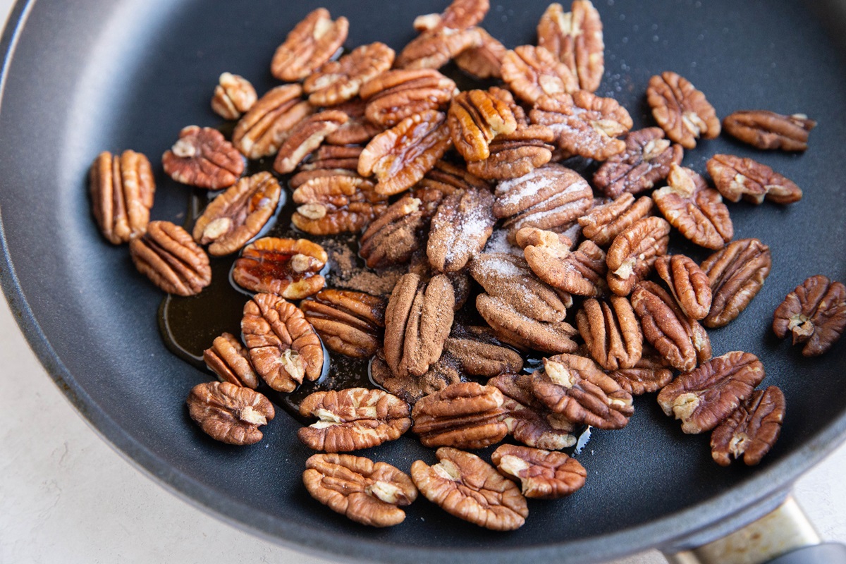 Ingredients for candied pecans in a skillet