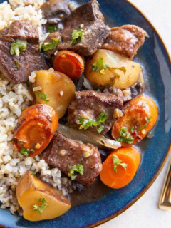 Blue plate with French beef stew and brown rice.