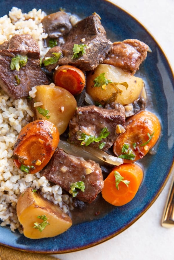 Blue plate with French beef stew and brown rice.