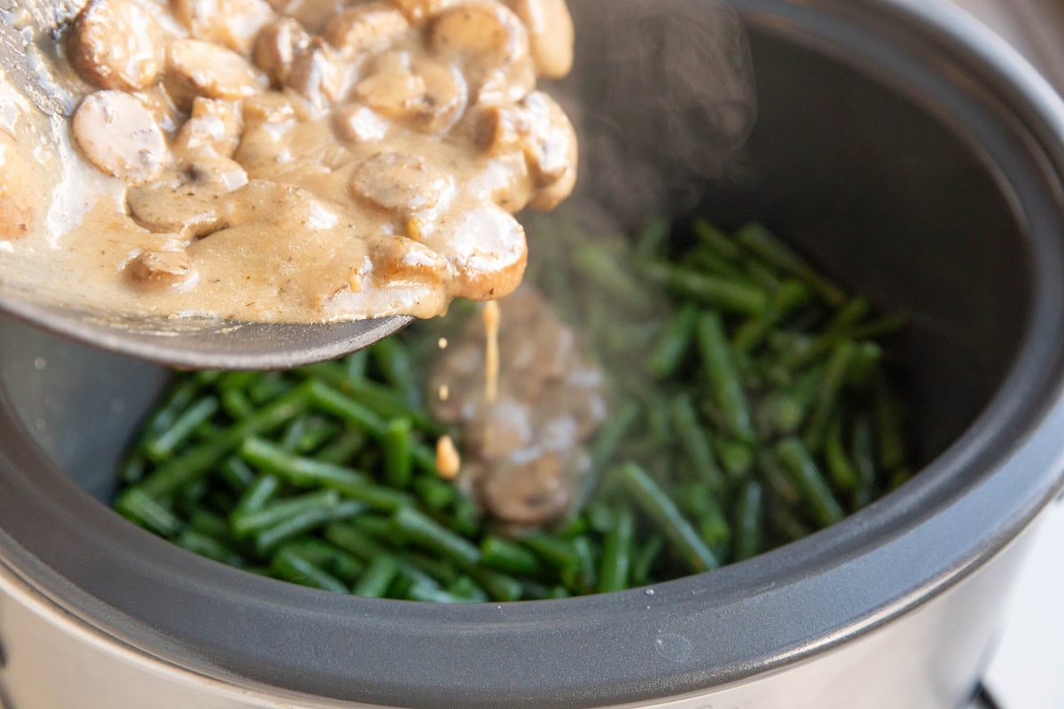 Pouring creamy mushroom sauce into the crock pot