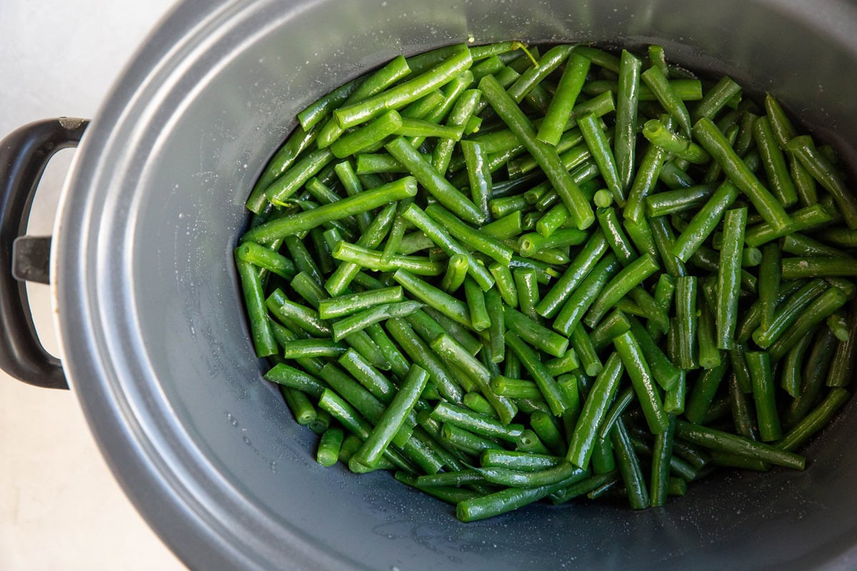 Green beans in a slow cooker to make green bean casserole.