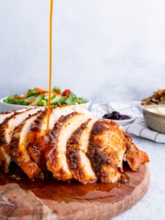 Gravy being poured on Garlic Butter Turkey Breast.