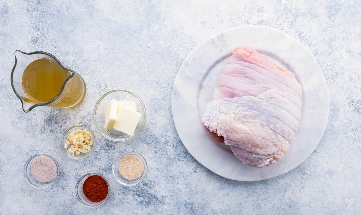 Ingredients for garlic butter turkey breast on a backdrop, ready to cook.