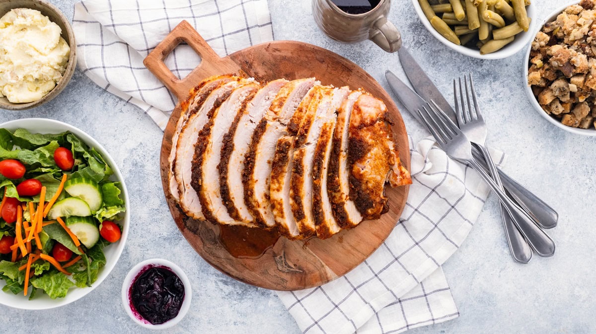 Sliced turkey breast on a cutting board.