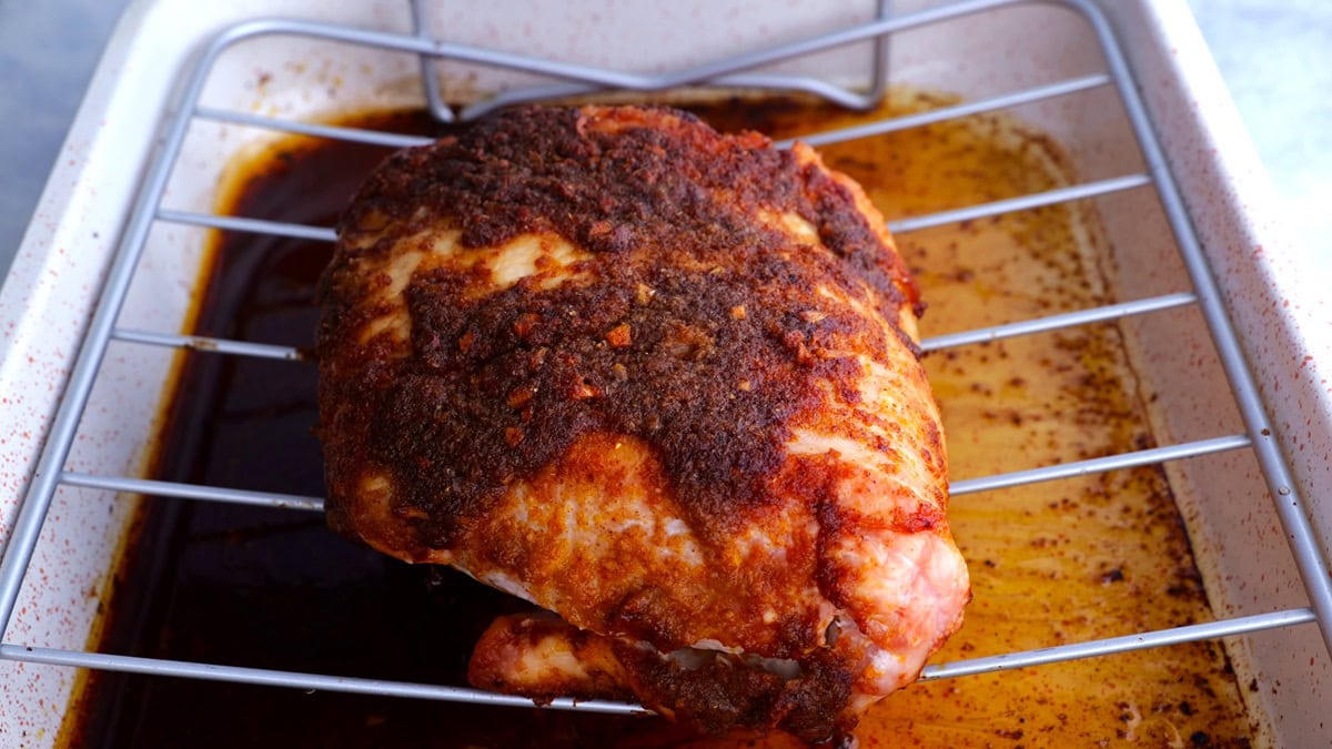 Cooked turkey breast in a roasting pan.