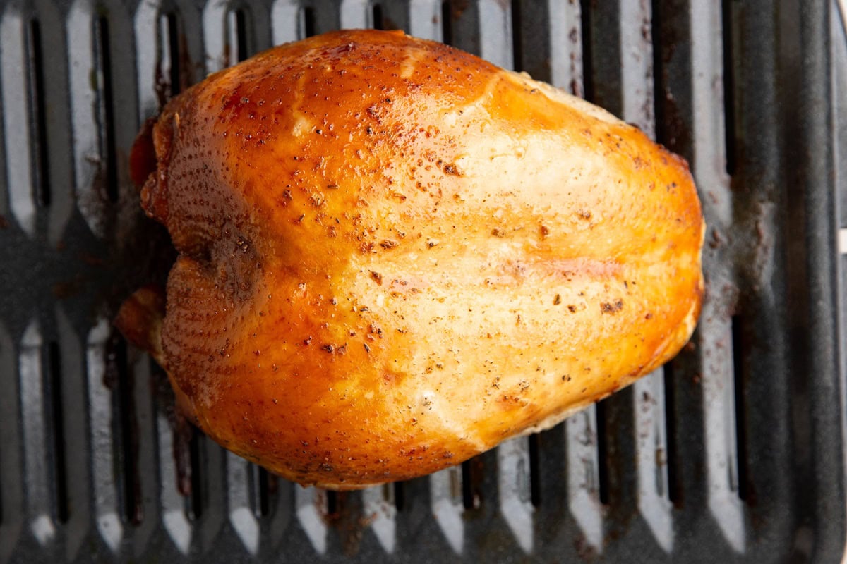 Roasted turkey breast on a roasting pan, fresh out of the oven.