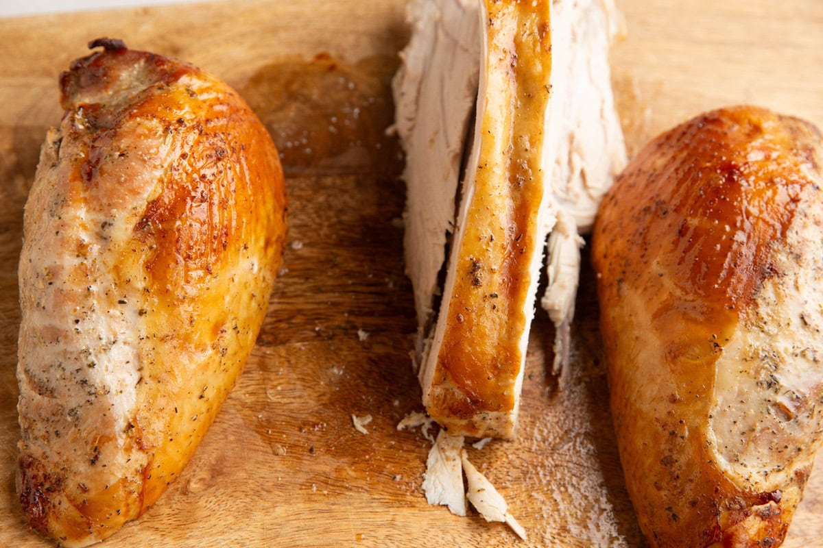 Two turkey breasts cut off of the breast bone, ready to be sliced.