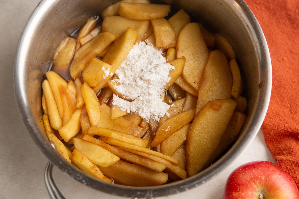 Softened apples in a saucepan with flour to thicken.