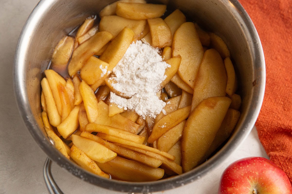 Softened apples in a saucepan with flour to thicken.