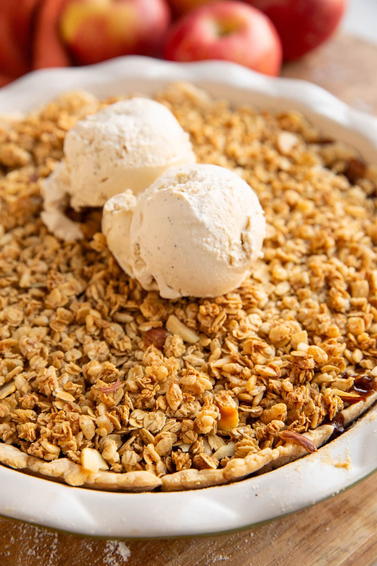 Apple Crisp pie with two scoops of vanilla ice cream on top.