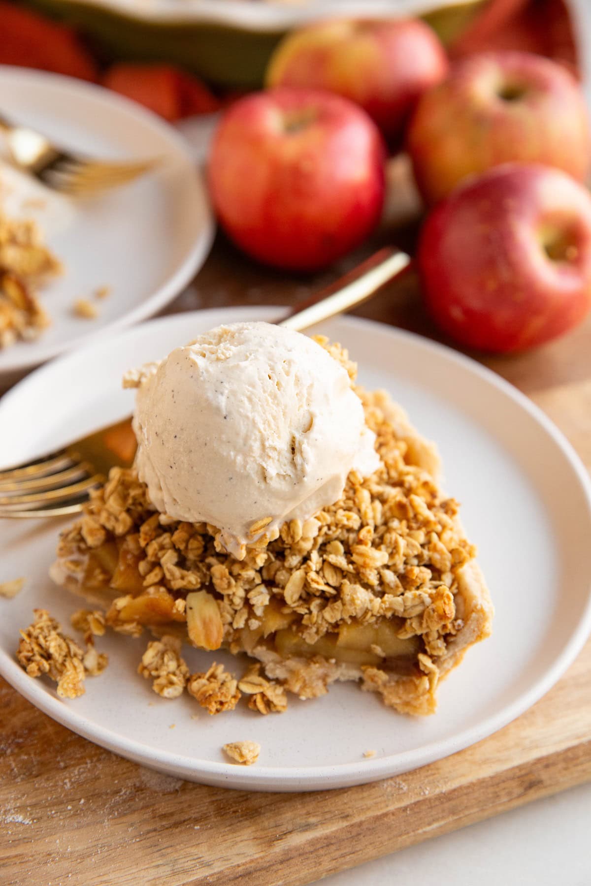 Two slices of apple pie with vanilla ice cream on top.