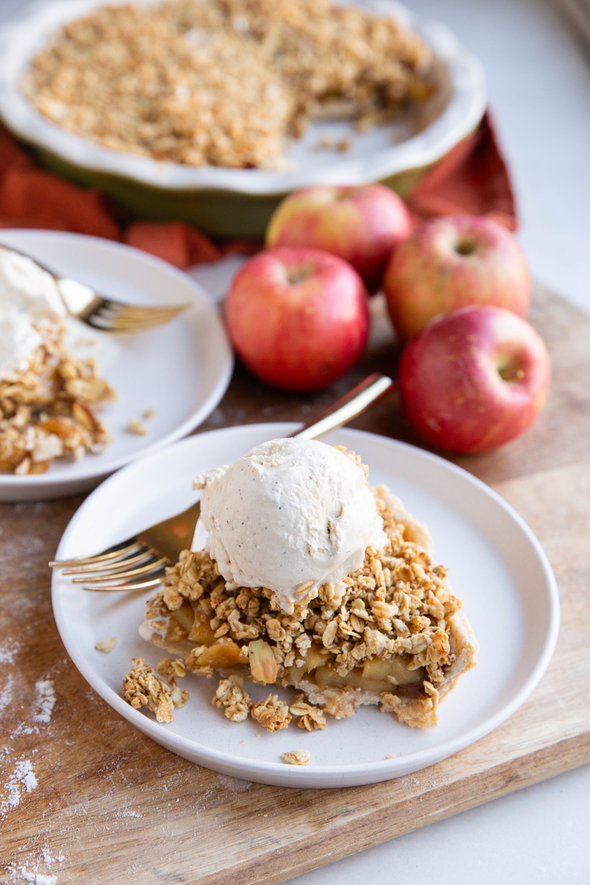 Apple pie with granola topping on two plates.