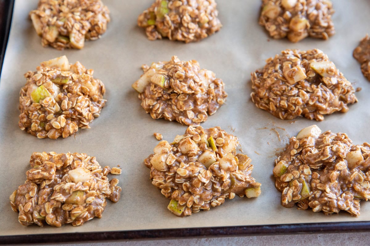 Mounds of pear cookie dough on a baking sheet, ready to go into the oven.