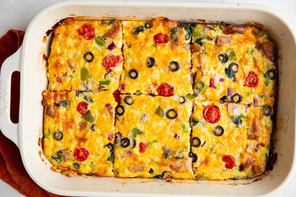 Sausage egg bake in a casserole dish cut into individual slices.