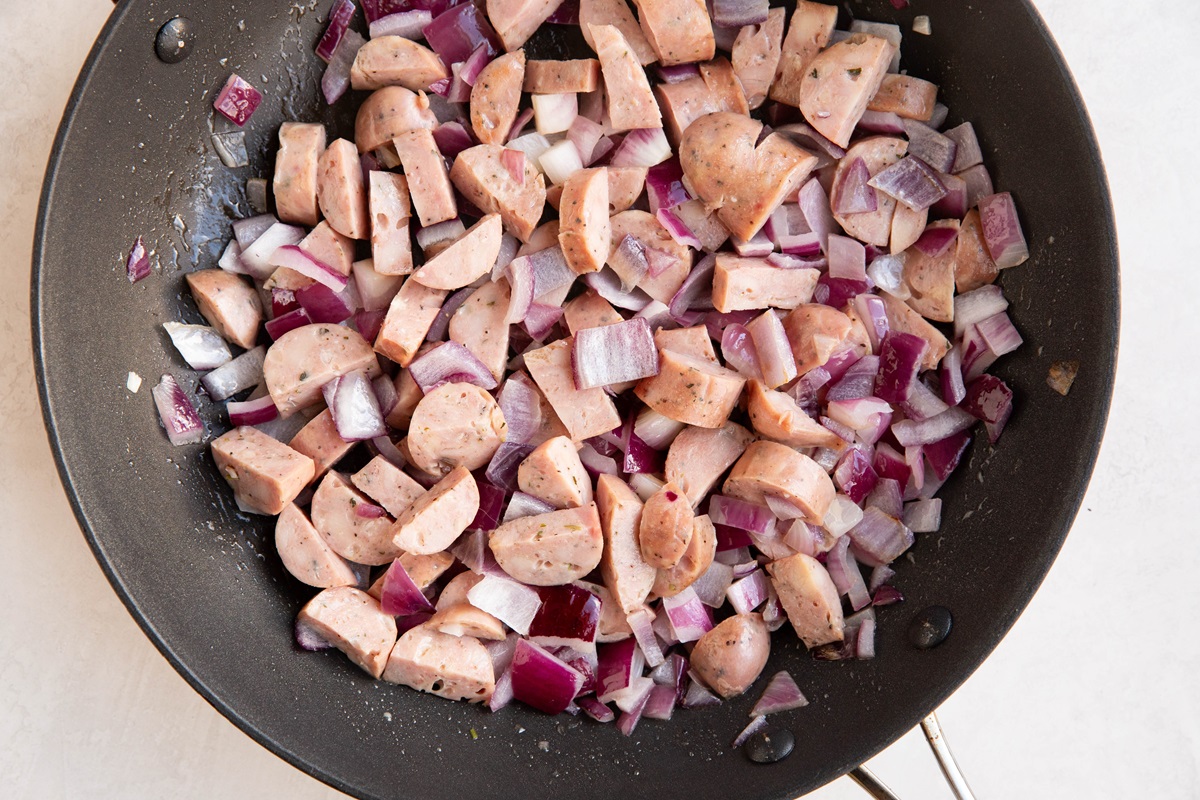 Onion, sausage and garlic cooking in a skillet
