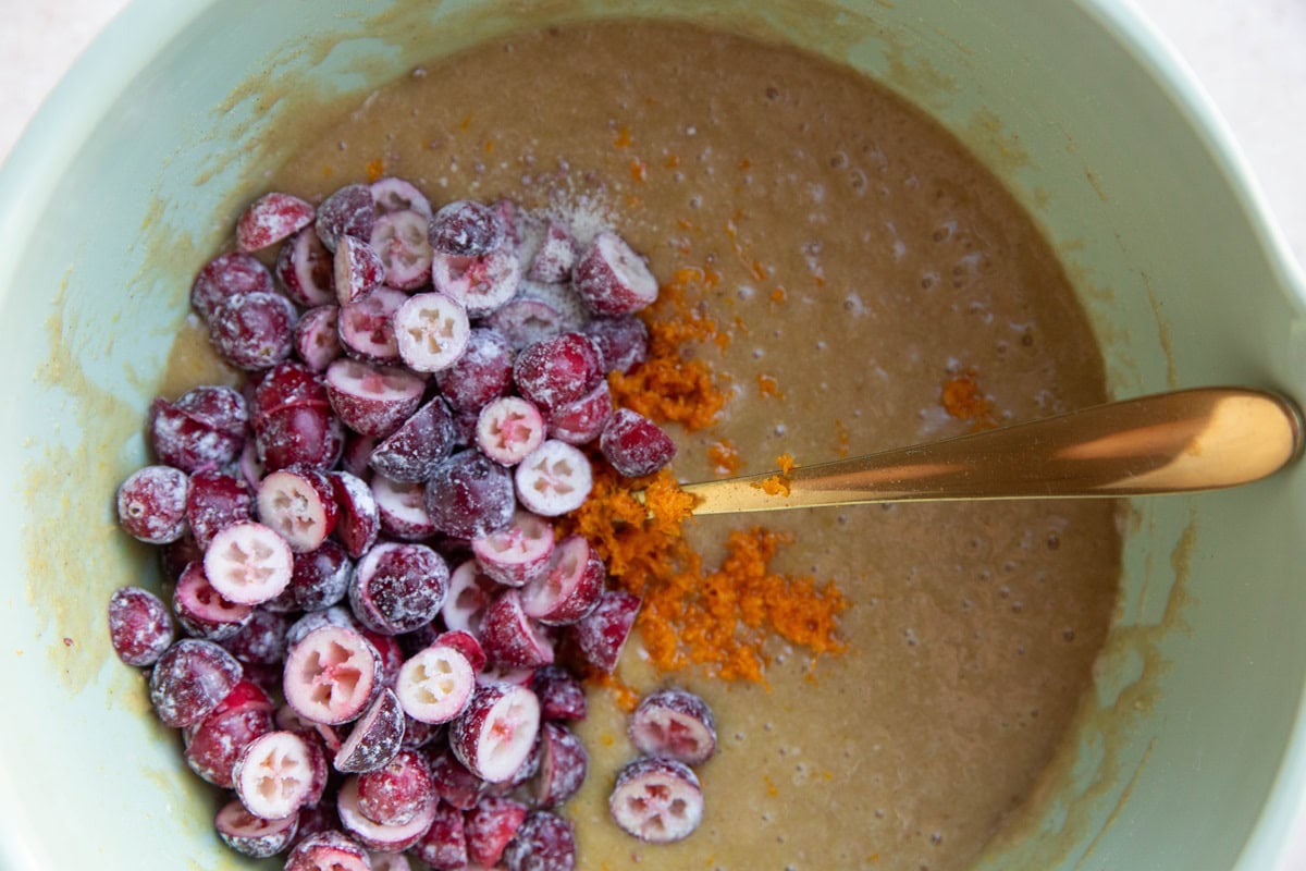 Coffee cake batter with cranberries and orange zest added in.