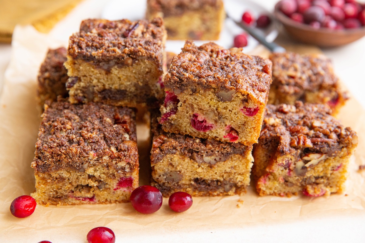 Cranberry orange coffee cake slices stacked on top of one another.