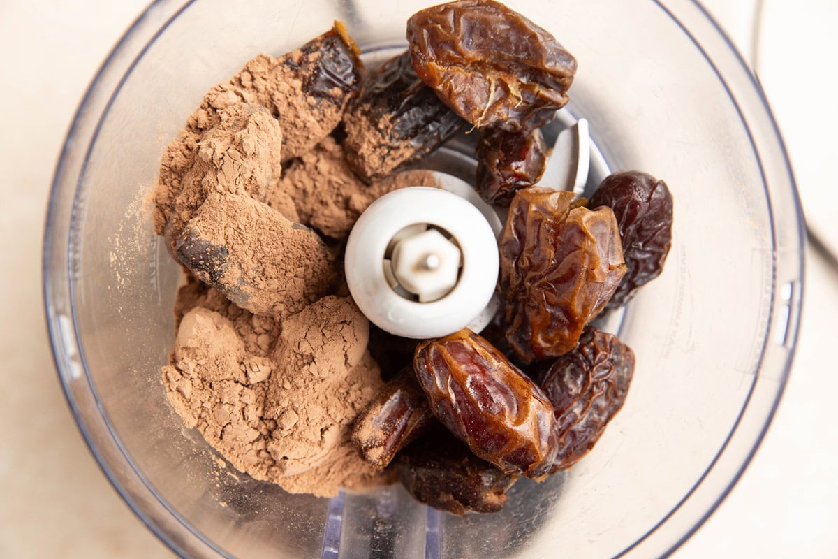 Dates and cocoa powder in a food processor to make healthy date balls.